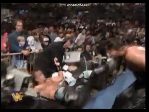 Kevin Nash powerbombs Shawn Michaels through table
