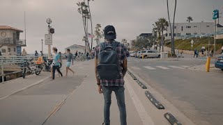  Man adjusts braids to go skateboarding