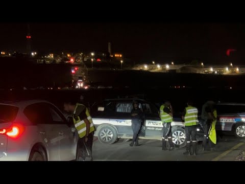 Rescuers at the scene of a drone strike near Israel's Binyamina | AFP