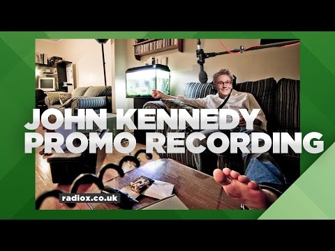 Where does John Kennedy record his promos?