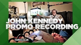 Where does John Kennedy record his promos?