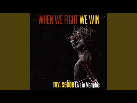 We Comin’ online metal music video by REV. SEKOU