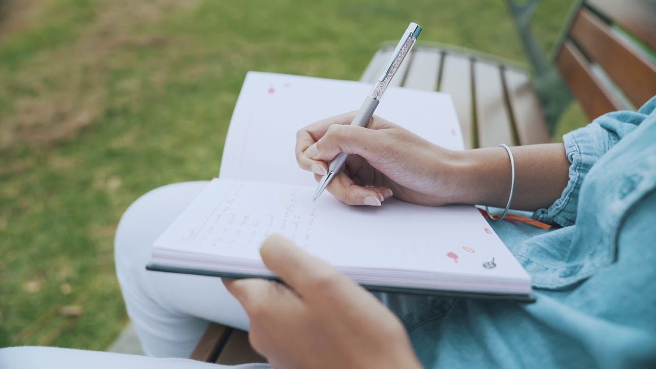 CLOSE UP Woman Writing in a Journal - HIGHEST QUALITY HD 4K Stock Footage