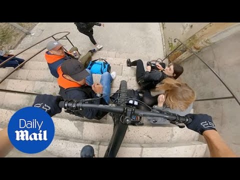 Close shave as cyclist narrowly avoids crashing into students