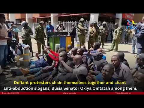 Protesters, including Senator Omtatah, chain themselves together and chant anti-abduction slogans