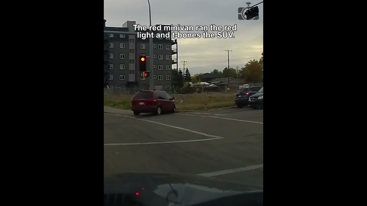 The red minivan ran the red light and t-bones the SUV.