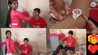 My sister is tying Rakhi to me