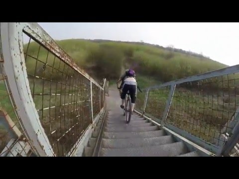 Down the steps on the bike at the  blue bridge