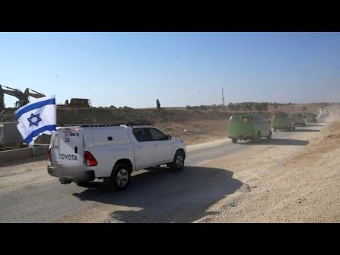 Israeli army images of convoy carrying released hostages crossing Gaza-Israel border | AFP