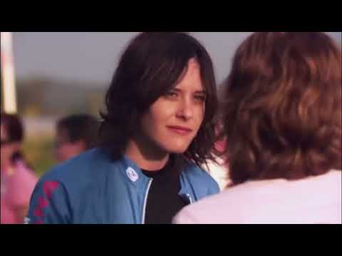 Trailer still: close-up of Jenny in reflective light as a quiet acoustic cue bleeds in