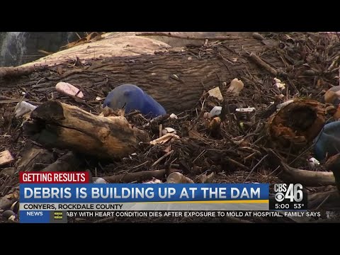 Flooding filth: Debris building up at dam