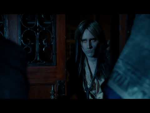 Trailer still: Laverne Cox’s Frank-N-Furter descending in the elevator toward a dazzled Brad and Janet