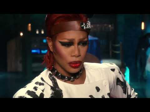 2016 Rocky Horror television event trailer still: neon marquee and Trixie the Usherette cue the curtain