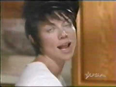 Promo still: Michael in profile, Nikita reflected on a monitor—Callery’s motifs implied under quiet dialogue