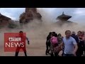 Nepal earthquake: Video shows terrified tourists as the temple collapses - BBC News