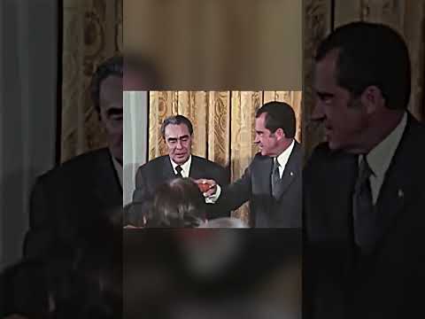 Soviet leader Leonid Brezhnev waits for President Nixon to drink champagne first