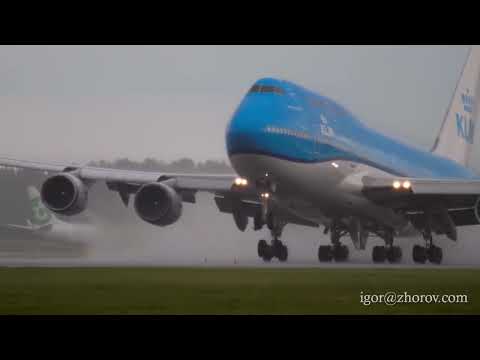 Jumbo Jet KLM takes off from a misty airport runway during a rainy day
