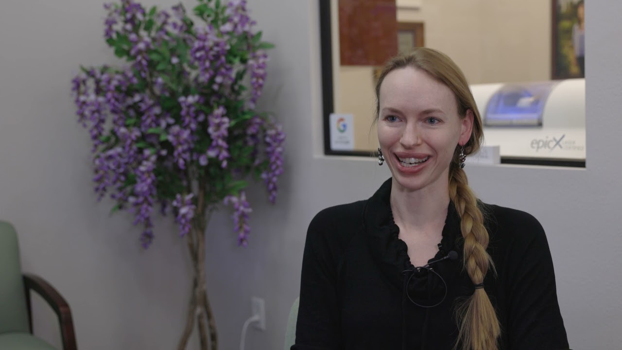 WOman with hair in long braid sitting in Henderson dental office