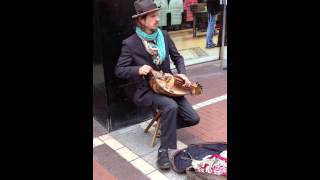 Busker playing a Hurdy-Gurdy on Grafton St. in Dublin, Ireland