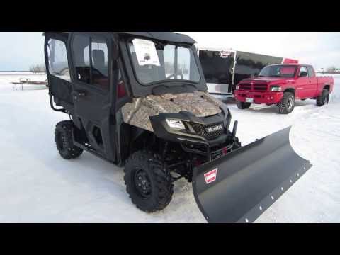 2014 Honda Pioneer 700-4 with Workman Cab, 72" Warn Blade and 4000lb Warn winch. Sold