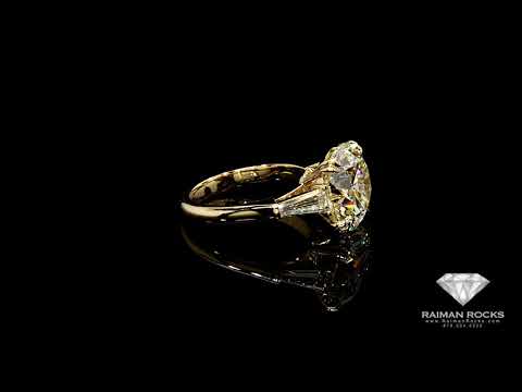 7.03ct, Round Brilliant Diamond Ring set in Yellow Gold with two tapered baguette side diamonds