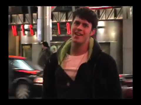 The Battery’s Down trailer still: creator-star Jake Wilson singing on a New York street