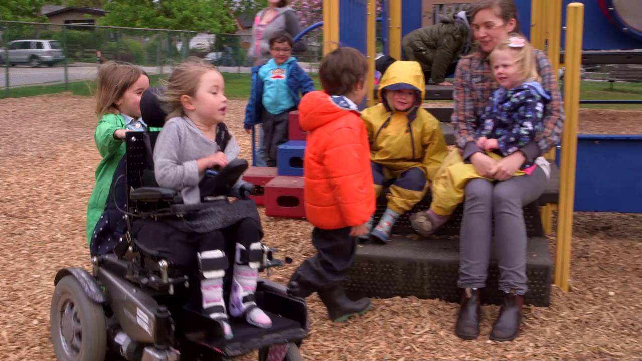 Olivia zooming around in her wheelchair at the playground