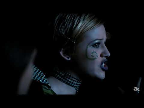Roswell Season 1 trailer frame: Max and Liz in the Crashdown Café, warm neon and lingering close-up