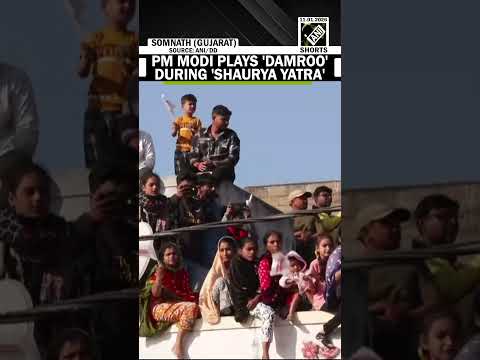 PM Modi plays the damroo during 'Shaurya Yatra at Somnath Swabhiman Parv