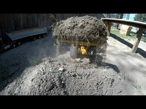 RC construction with heavy equipment building a bridge ramp