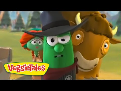 Green vegetable character wearing a black hat, with a bronze-brown animal beside him, in a VeggieTales scene with a yellow VeggieTales logo bottom left.