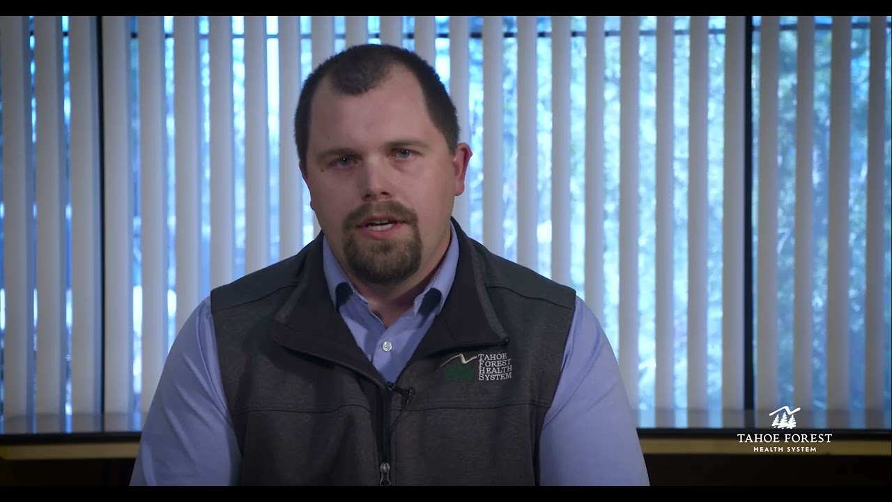 Dylan Crosby, VP of Facilities and Construction, sitting in front of a window