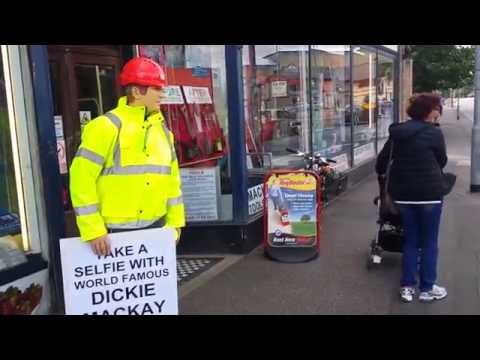 Dickie Mackay, the Cambridge Dickies mannequin comes alive mannequin-man performming as a Mechanical Mannequin: Taking the place of Dickie Mackay, the mannequin that has been standing outside Mackays of Cambridge for years. Passers-by got a shock when taking a selfie with the mannequin, when he suddenly comes to life.
In this one a woman gets a shock. for Mackays on 23/08/2014
