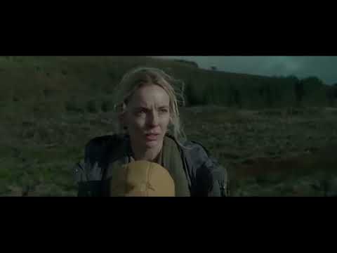 Official trailer still for The End We Start From with Jodie Comer holding her newborn amid grey floodwater light