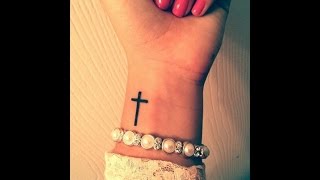 small cross tattoo on wrist