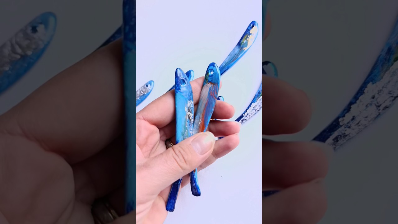 Coastal wall art installation with handmade clay fish for beach home decor