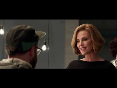 Trailer frame: Charlotte on a balcony phone call, city lights soft behind her