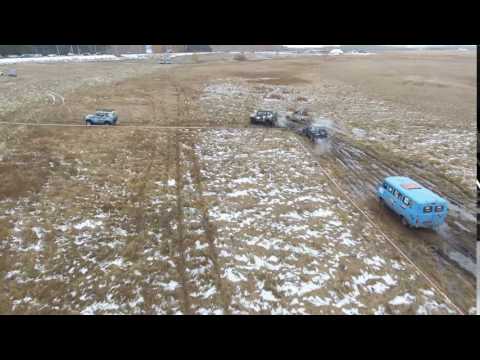 Off-road cars rides through countryside. Aerial shooting