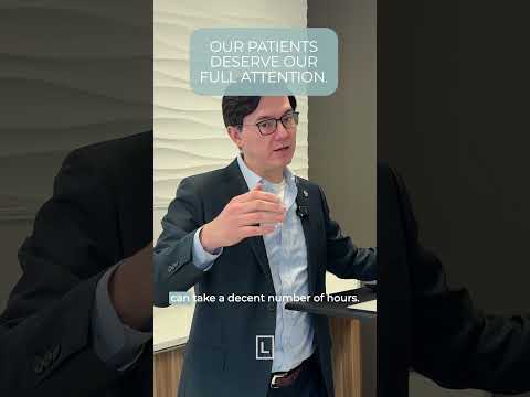 Dr. Leong standing next to a patient with a blue background