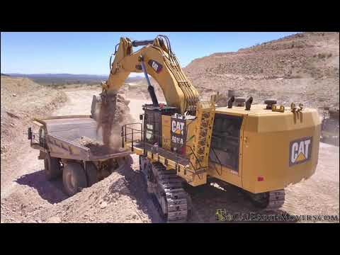 CAT 6015B Excavator Loading 100 Ton Haul Trucks