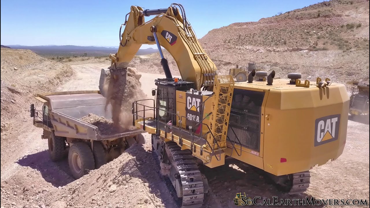 CAT 6015B Excavator Loading 100 Ton Haul Trucks