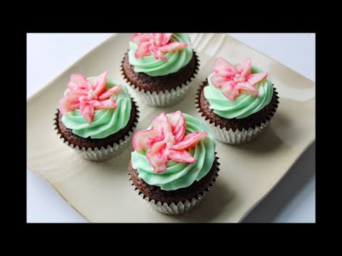 Pipe a buttercream lily and a rosette swirl on a cupcake tutorial with recipes in description