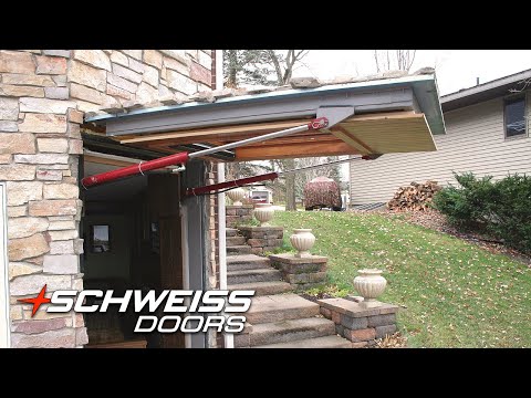 A Schweiss Hidden Hydraulic Door with matched cladding at the Buboltz home