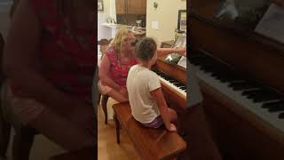 Video clip of a piano and flute lesson. She has be