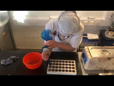 Milk chocolate pralines filled with caramel and hazelnut