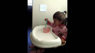 Carly drinks her Cheerios milk.