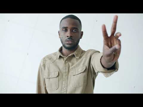 Slow motion portrait of serious African American man counting with fingers looking at camera