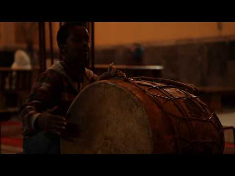 Boy playing drums in a church, Asmara, Eritrea