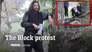 Protestor storms Block auctions with a megaphone