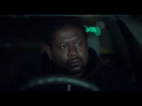Final trailer image with Whitaker in silhouette, city sodium lights behind—music implies ritual closure